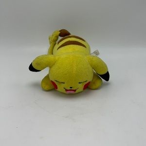 T0004 pikachu laying down stuffed animal